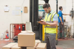 36413120 - warehouse worker with clipboard in warehouse