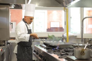 7875436 - cook preparing food in a pan